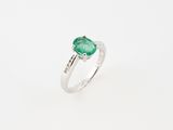 Gros plan sur une bague ornée d'une pierre verte