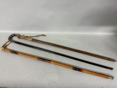three wooden canes are sitting on top of a white surface