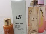 a bottle of liquid next to a box and a bottle of lotion