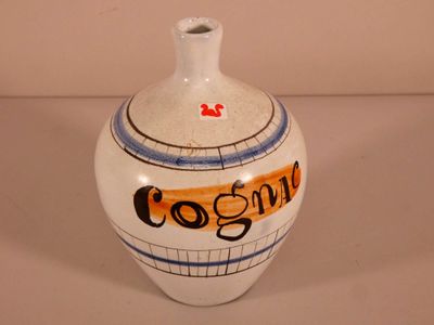 a white vase with an orange and blue design on it
