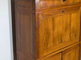 a wooden cabinet with a marble top in a room