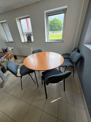 a room with a table and chairs in it
