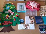 a table that has a christmas tree, books, and other items on it