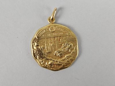 a close up of a gold medal on a white surface