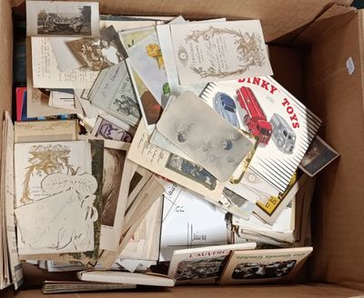 a cardboard box full of old postcards and postcards