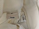 a label on the inside of a white jacket
