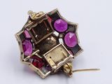 an image of a close up of a purple and red broochle