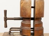 a wooden vise that is on top of a piece of wood