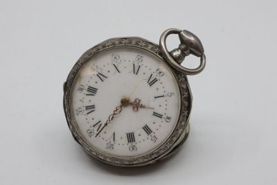 a silver pocket watch with roman numerals on it