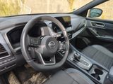 a steering wheel and dashboard of a car in a field