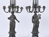 paire de candélabres anciens en bronze représentant une femme tenant un livre et un candélabre