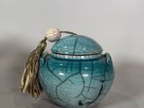 a blue vase with a flower on top of it