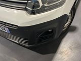 the front end of a white van parked in a garage