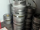 a stack of beer kegs sitting on a counter in a kitchen