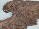 carvings of an eagle made of wood on a white surface
