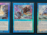 three cards with different designs on them on a blue background