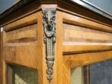 a close up of a wooden cabinet with a glass door