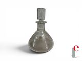 a glass bottle that is sitting on a white surface