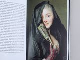 an open book with a picture of a woman in a black dress