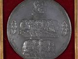 a close up of a silver medal with a picture of a man on a horse