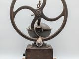 an old machine that is sitting on top of a wooden stand