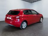 the rear end of a red car parked in a garage