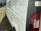 a white van with a ladder on the back of it