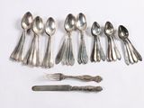 a lot of spoons and forks on the table