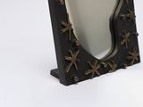 a mirror with crosses on it on a white surface