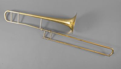 an old brass trombone with a long neck and a long horn