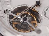 a close up of a silver watch with a white face