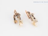 pair of earrings with pearls and diamonds on a white background