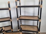 three black and wicker chairs are sitting on a wooden floor