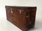 an old trunk sitting on top of a white surface