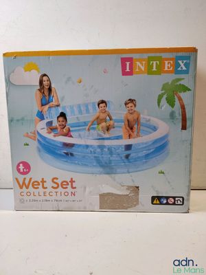 an inflatable swimming pool with three children sitting on it