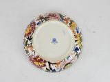 a plate with a floral design on it sitting on a table