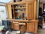 une grande armoire en bois sur laquelle sont posés de nombreux plats