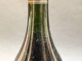 a close up of a bottle of wine sitting on a table