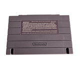 a nintendo game console sitting on top of a white surface