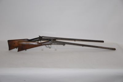 an old rifle with a wooden barrel on a white surface