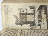 an open book with a drawing of a house on it