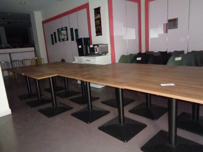 tables and chairs in a room with red walls and white walls