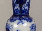 a blue and white vase sitting on a table