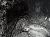 black and white photograph of a horse carved into the side of a rock
