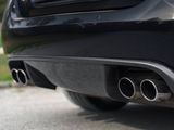 a close up of a black car parked on the street