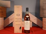 a bottle of wine sitting next to some wooden boxes