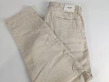beige pants on a white surface with a white background