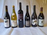 several bottles of wine are lined up in a row on a table