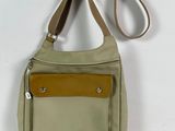 beige and brown purse with a leather strap on a white background
