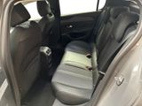 the back seat of a car with the door open and the driver ' s seat down